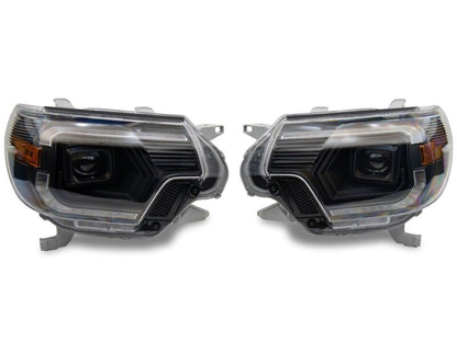 Raxiom 12-15 Toyota Tacoma Axial Series Switchback Projector Headlights- Black Housing- Clear Lens