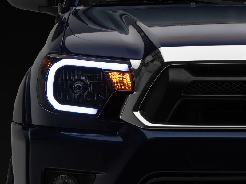 Raxiom 12-15 Toyota Tacoma Axial Series Headlights/Seq LED Bar- Black- Clear Lens