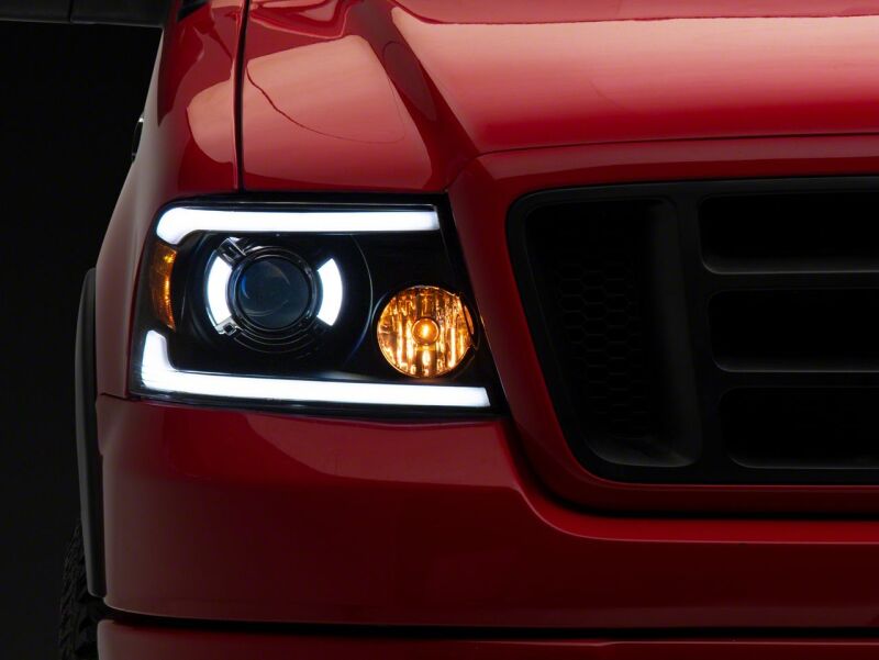Raxiom 04-08 Ford F-150 Axial Series Projector Headlights with LED Bar- Black Housing- Clear Lens